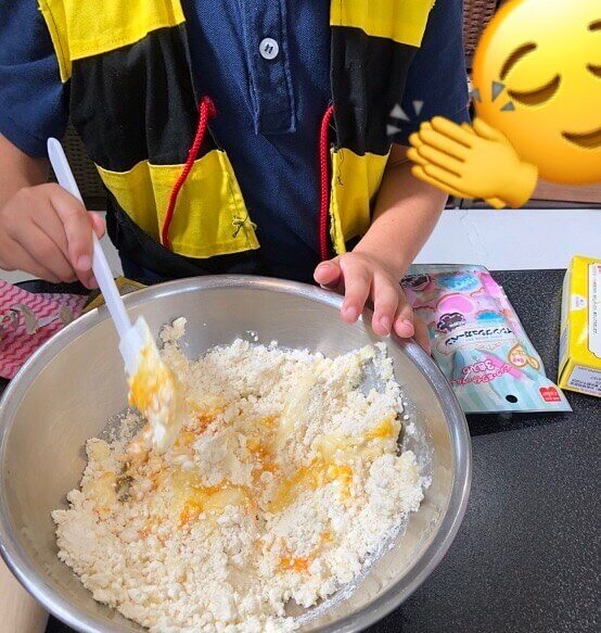 子供がクッキーミックスを混ぜている写真